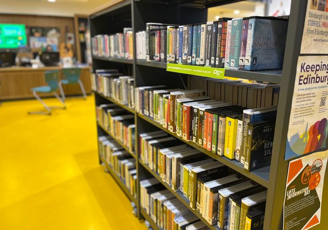 Photo of bookshelves with audio books at Muirhouse Library
