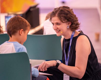 Author Chloe Savage talking to a child in the audience during an event