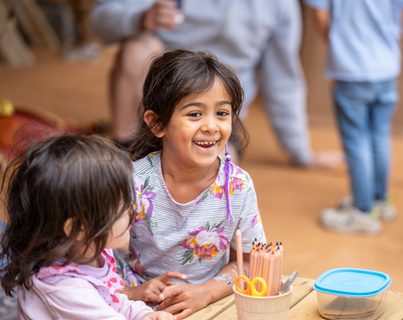 Kids in Children's Tent with colouring pencils