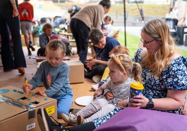 Family doing a craft in the Kids Zone