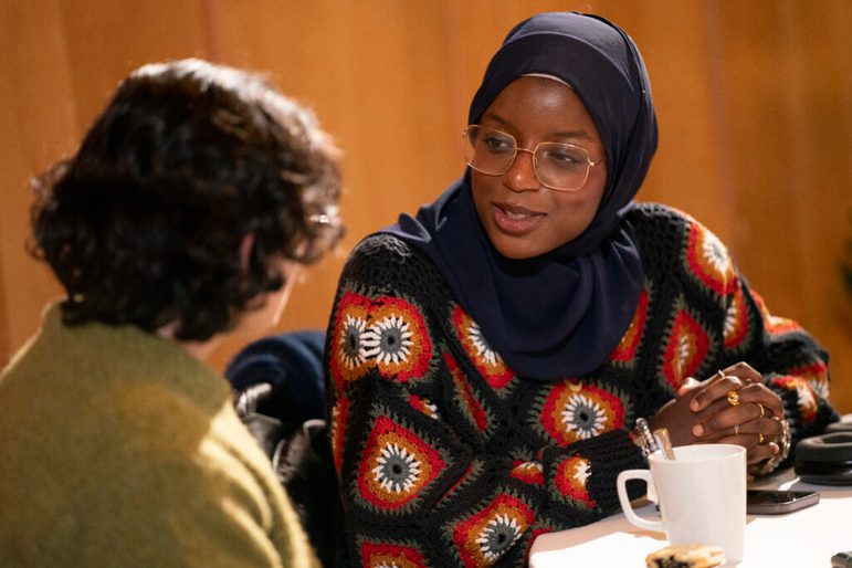 Two people talking at a table