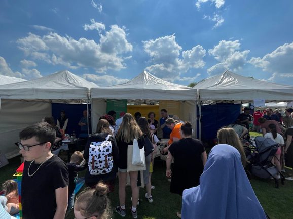 Group of people standing in line at a tent