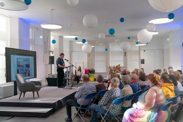 Crowd watching a speaker on stage