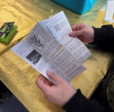 Person holding open a zine