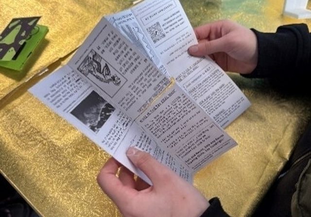 Person holding open a zine