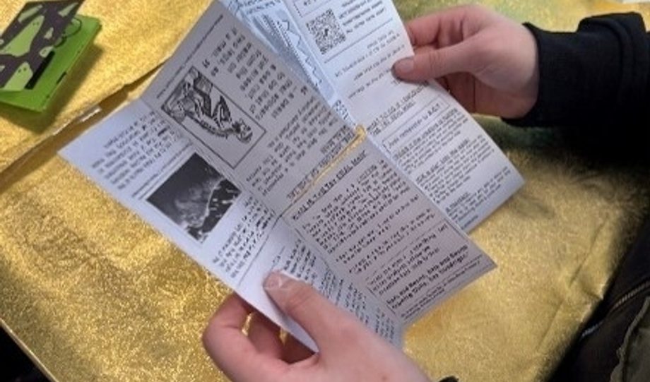 Person holding open a zine