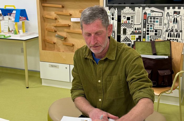 Author Mike Nicholson signing a book at Edinburgh Sick Kids