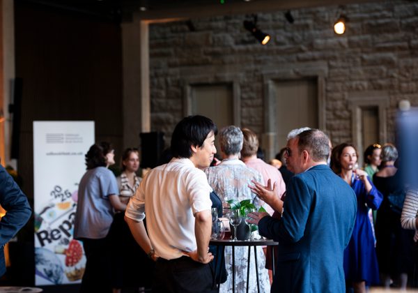 People at a hospitality event chatting and mingling