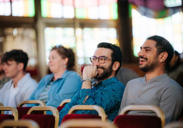 Audience members laughing
