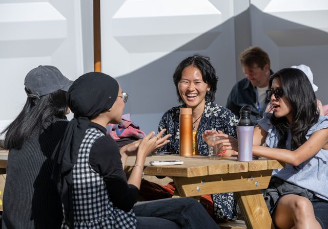 Group of people laughing sitting in Book Festival courtyard