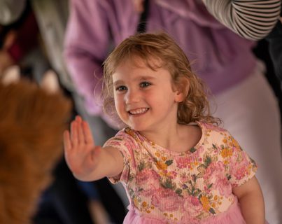Child with hand up for a high five