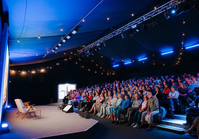 Inside of Courtyard Theatre with stage on left and audience in raked seating on the right
