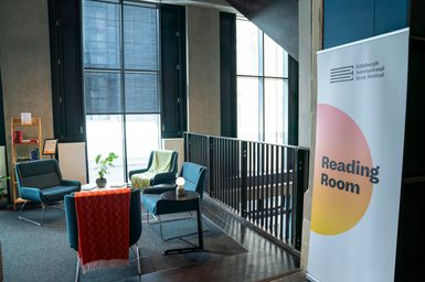 A sign that says 'reading room' and some comfortable seats